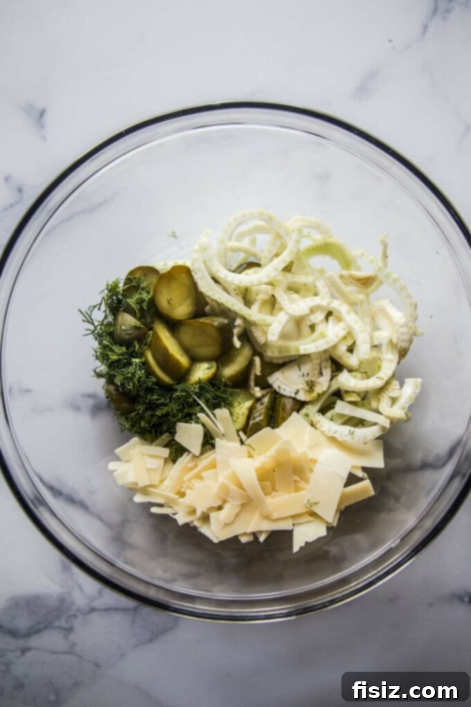 Zesty Pickle Panzanella 6 Freshly sliced pickles, fennel, Parmesan, and dill ready for mixing