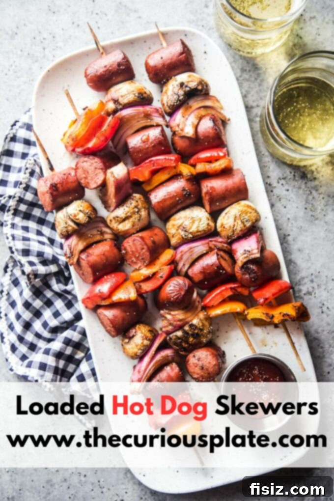 Epic Hot Dog Skewers 11 A beautifully presented plate of Loaded Hot Dog Skewers with a side of fresh salad, ready to be enjoyed.