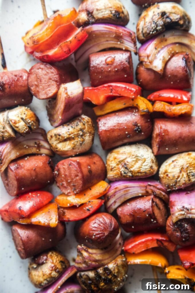 Epic Hot Dog Skewers 3 Close-up of vibrant Loaded Hot Dog Skewers ready for grilling, showcasing chopped vegetables and hot dog pieces.