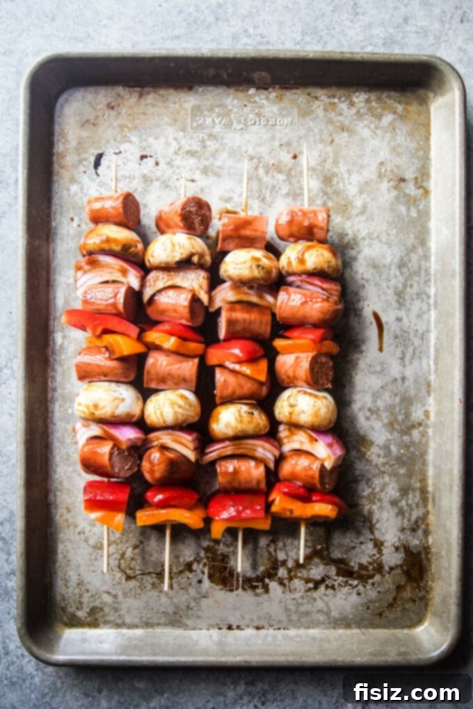 Epic Hot Dog Skewers 6 Assembled Loaded Hot Dog Skewers with colorful vegetables and hot dog pieces, ready to be grilled.