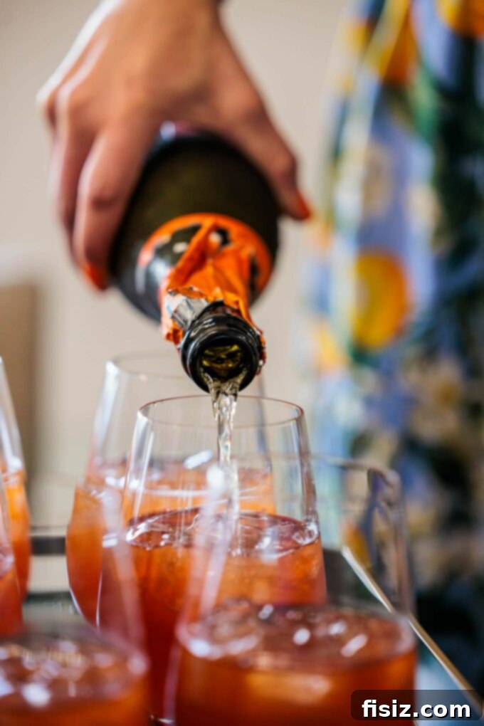 Elevate Your Outdoor Entertaining 5 Pro Tips 5 Pouring champagne into cocktail glasses with fruit garnish