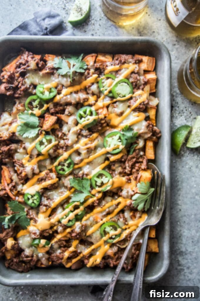 Korean BBQ Nachos Supreme 7 A generous serving of Beef and Kimchi Sweet Potato Nachos, piled high with toppings and ready to be enjoyed.