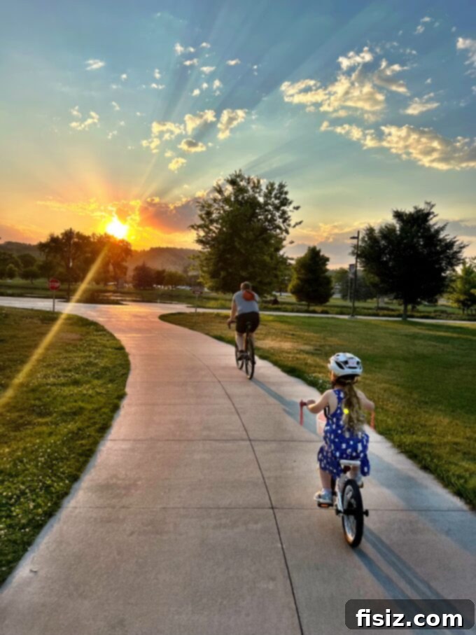 Rapid City South Dakota Stay Eat Explore 31 Scenic pathway through Memorial Park in Rapid City, surrounded by lush greenery and sculptures.