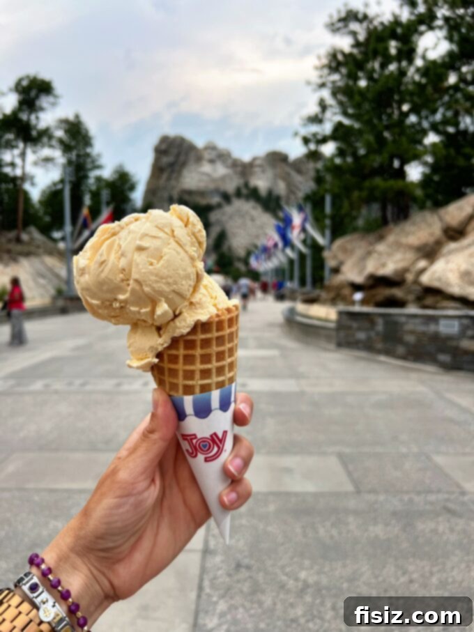 Rapid City South Dakota Stay Eat Explore 39 Visitors walking the Presidential Trail at Mount Rushmore, enjoying close-up views and natural scenery.