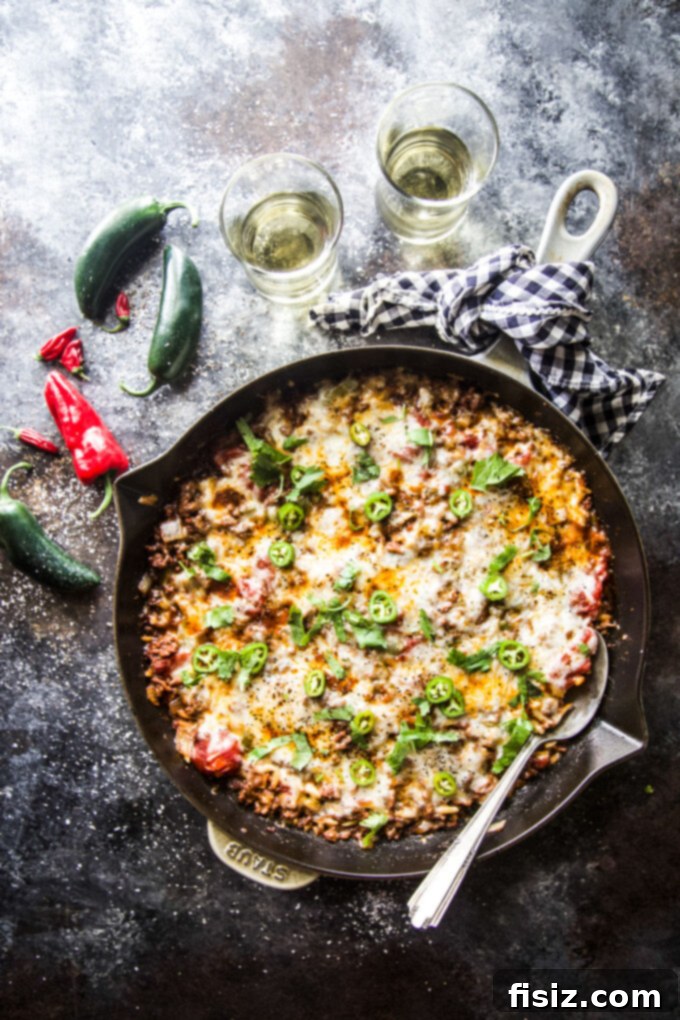 Fiery Beef Orzo 7 Chili Spiced Beef Orzo served in a bowl with a spoon, ready to eat