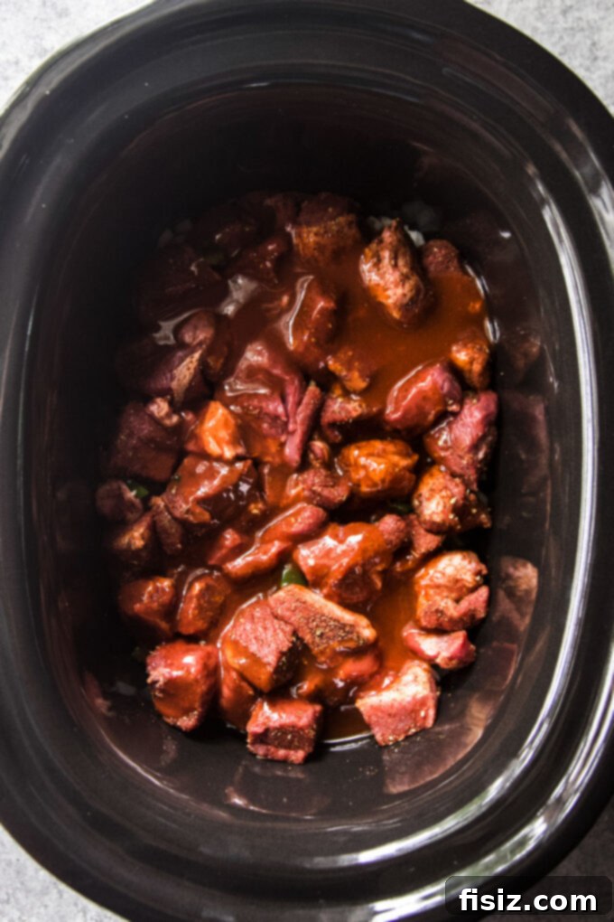Tender Slow Cooker Tex-Mex Lamb Tortilla Soup 6 Seasoned American lamb shoulder placed in a slow cooker with onions, jalapenos, and garlic