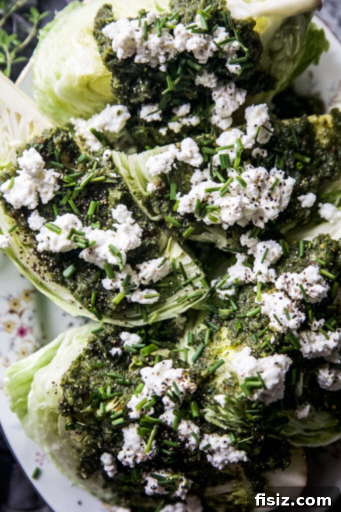 Zesty Tabouli Wedge 8 A vibrant, fresh Easy Tabouli-Style Wedge Salad, showcasing the crisp lettuce, colorful dressing, and toppings on a white plate.