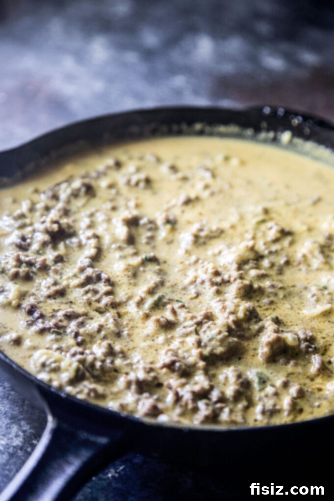 Smothered Beef and Pumpkin Enchiladas 7 pumpkin beef sauce cooking in skillet