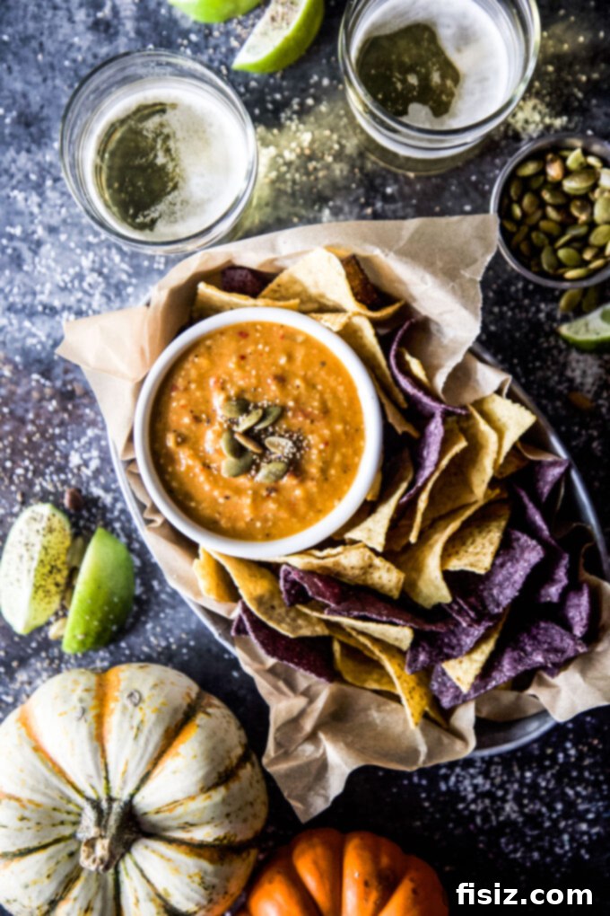 Tangy Heat Pumpkin Tomatillo Salsa 2 A vibrant bowl of Spiced Pumpkin Tomatillo Salsa, garnished with fresh herbs and served with tortilla chips.
