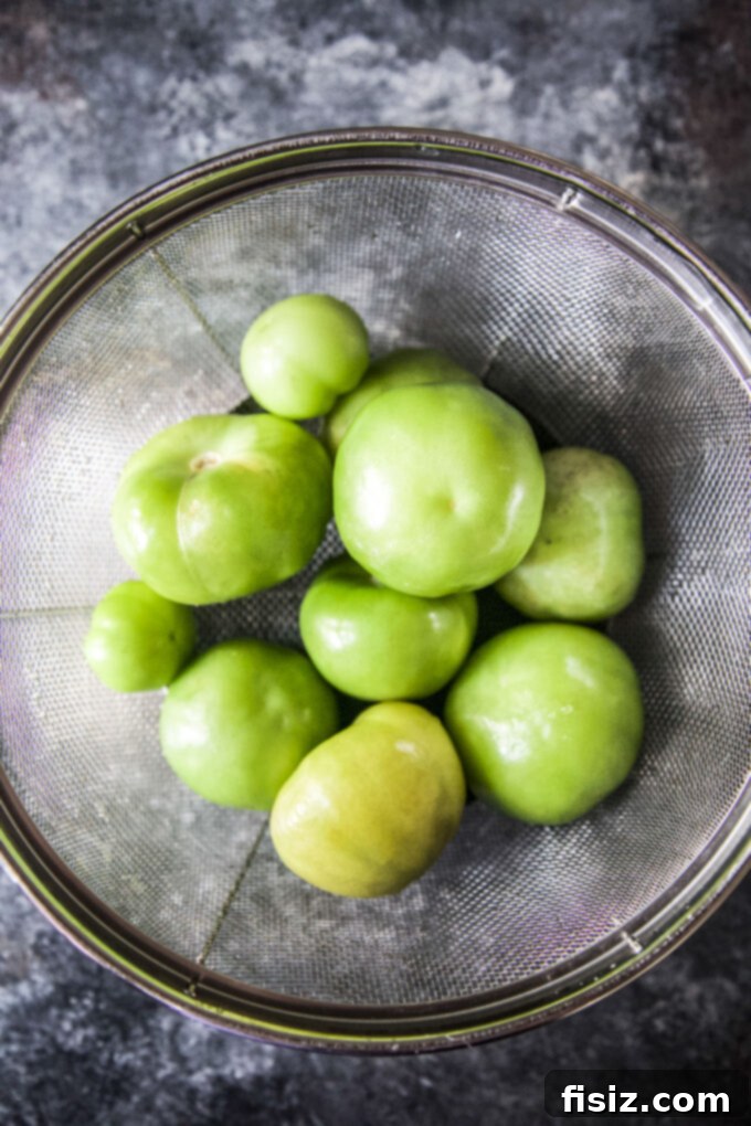 Tangy Heat Pumpkin Tomatillo Salsa 4 Freshly cleaned tomatillos, bright green and smooth, waiting to be cooked.