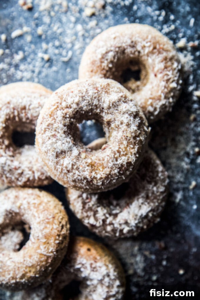 Heavenly Baked Coconut Cardamom Pecan Doughnuts 3 Close-up of a beautifully coated Coconut Cardamom Pecan Baked Doughnut