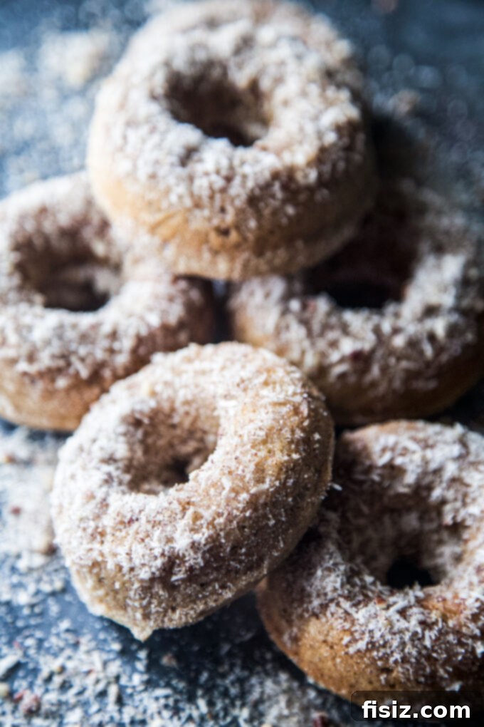 Heavenly Baked Coconut Cardamom Pecan Doughnuts 9 A stack of Coconut Cardamom Pecan Baked Doughnuts in a beautiful serving dish