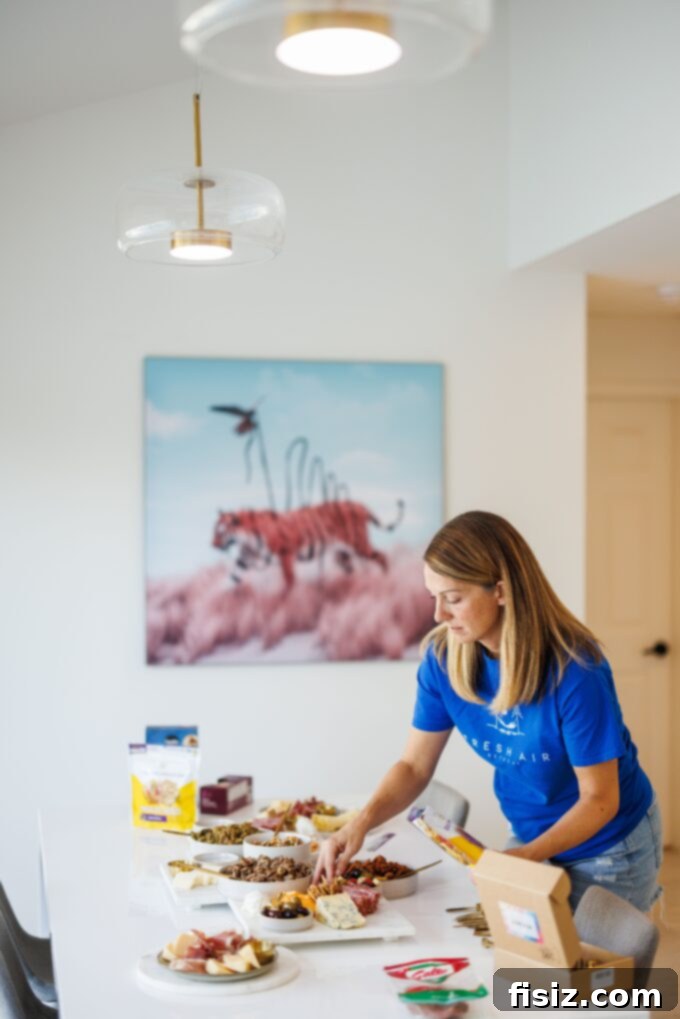 Five Keys to Stress-Free Holiday Hosting 3 Woman smiling, serving food at a beautifully decorated holiday table