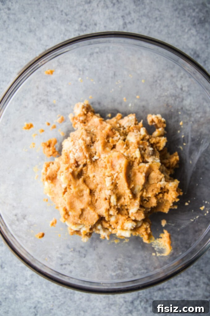 Pumpkin Pie Energy Bites with Toasted Pepitas 5 Pumpkin pie bites chilling on a parchment-lined baking sheet