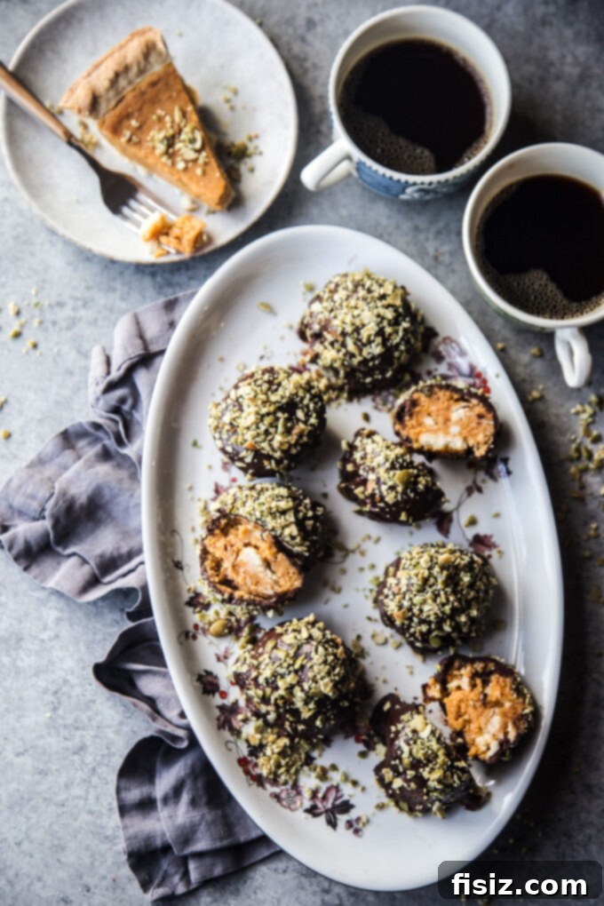 Pumpkin Pie Energy Bites with Toasted Pepitas 8 Decorated Leftover Pumpkin Pie Bites on a rustic wooden board