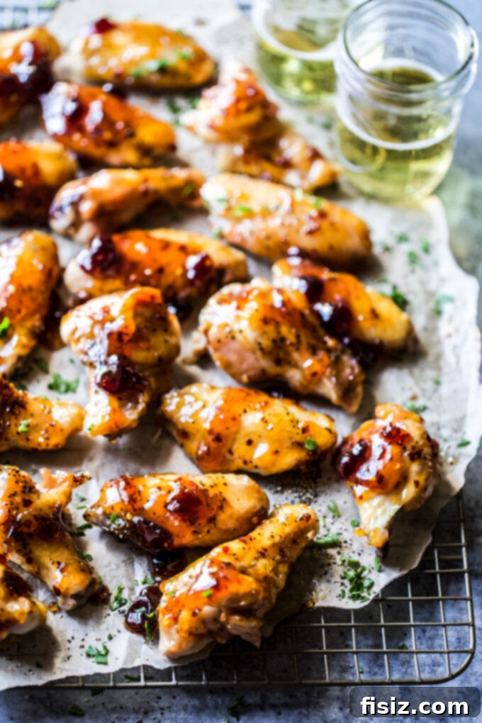 Tangy Cranberry Mustard Baked Wings 6 Oven-Baked Spiced Cranberry & Mustard Glazed Chicken Wings on a plate