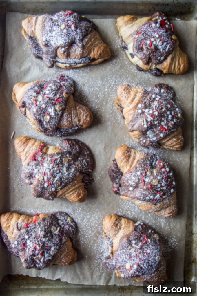 Chocolate Mint Croissant Bliss 6 Baked Peppermint Brownie Batter Croissants cooling on a baking sheet.
