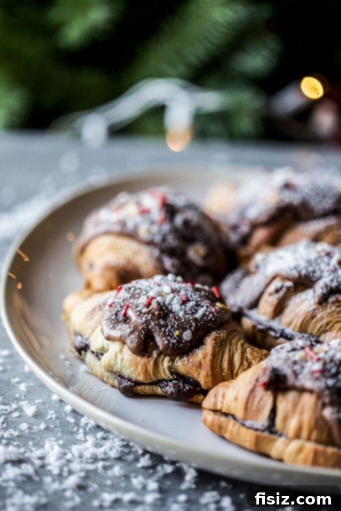 Chocolate Mint Croissant Bliss 8 A stack of Peppermint Brownie Batter Croissants with powdered sugar dusting.