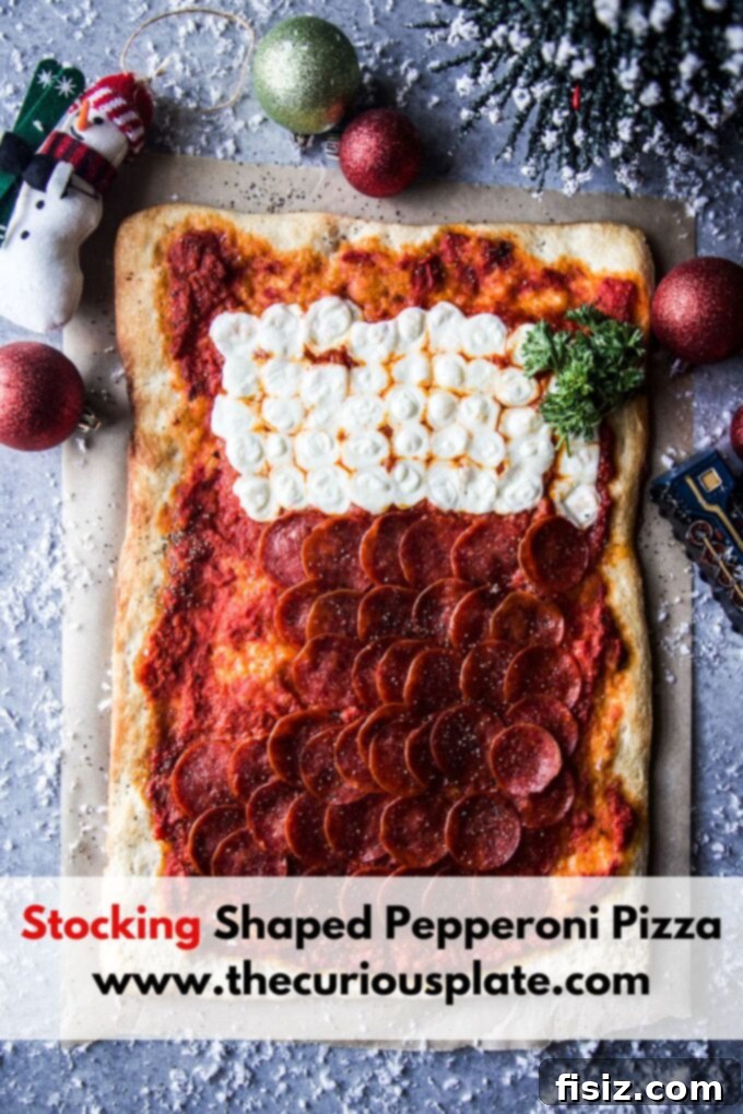 Overhead view of a beautiful stocking shaped pepperoni pizza on a rustic wooden table