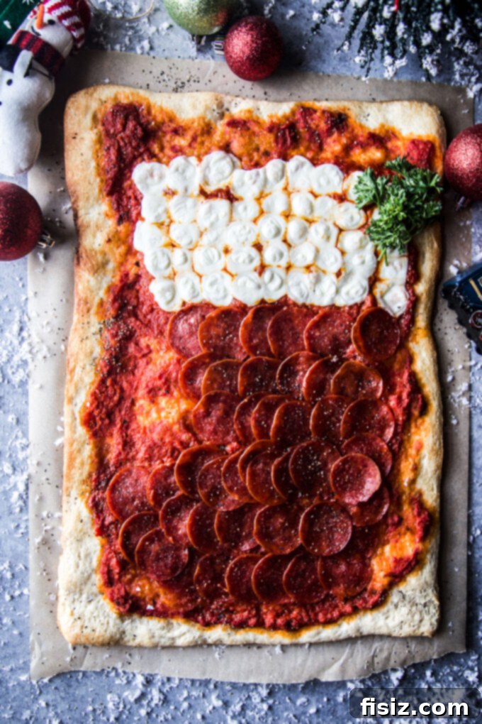 Close up of a decorated stocking shaped pepperoni pizza on a wooden board