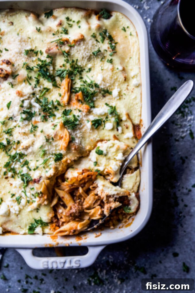 high-protein greek baked ziti baking in an oven