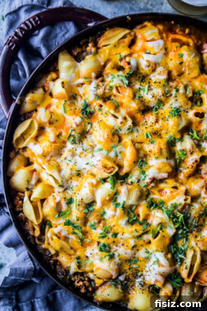 One-Pan Buffalo Chicken Chili Pasta 3 Close-up of a serving of Buffalo Chicken Chili Pasta Skillet, garnished with fresh herbs and a drizzle of ranch.