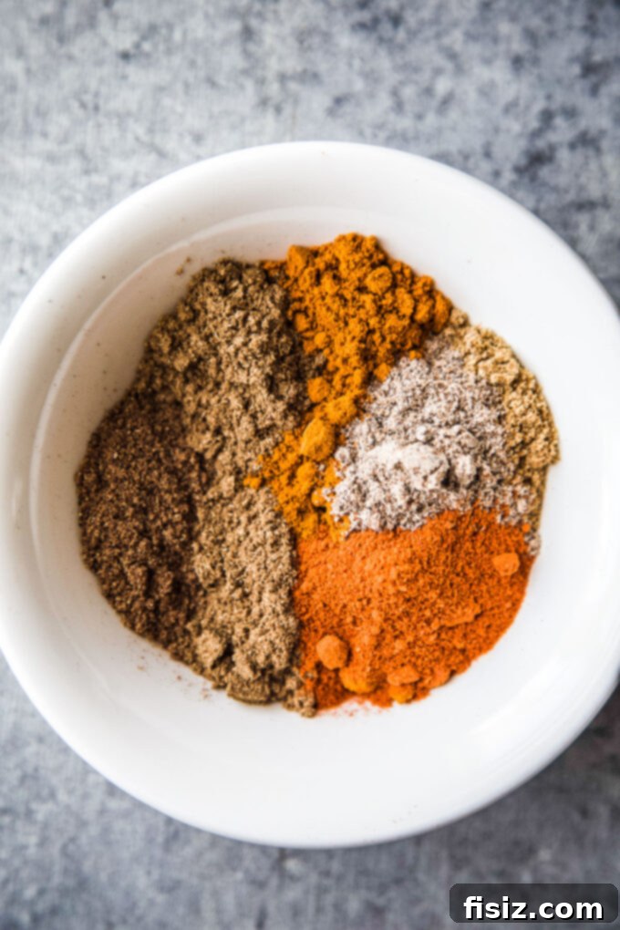 Zesty Indian Chicken Tenders with a Cooling Ranch Dip 4 A close-up of various Indian-inspired spices in small bowls, ready for mixing.