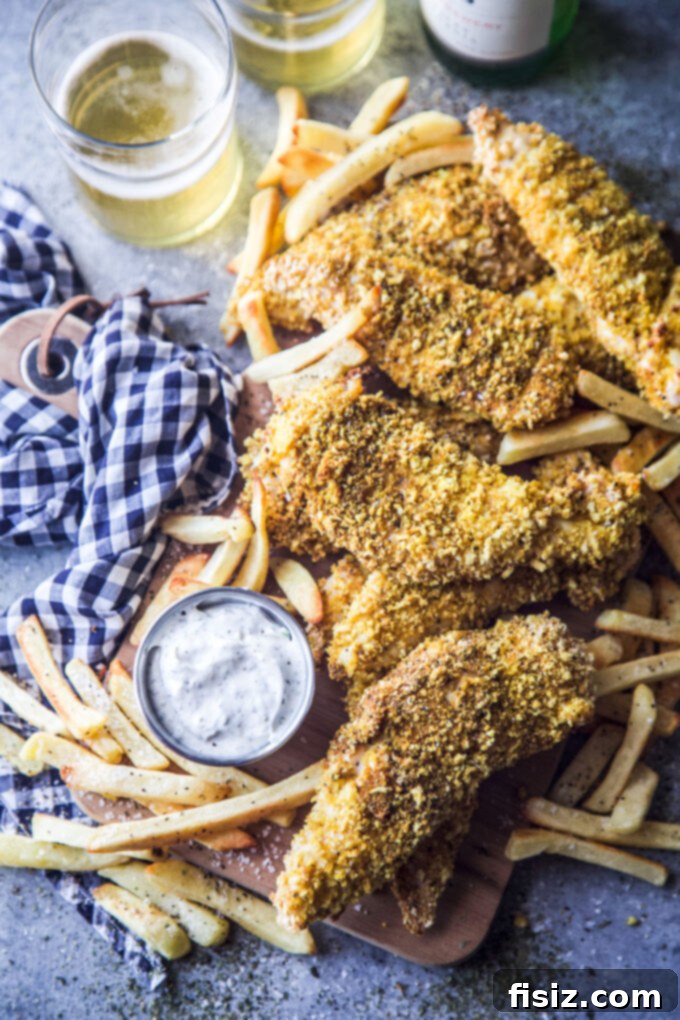 Zesty Indian Chicken Tenders with a Cooling Ranch Dip 8 A serving of Indian Spiced Chicken Tenders with Cool Ranch Dipping Sauce and fries.