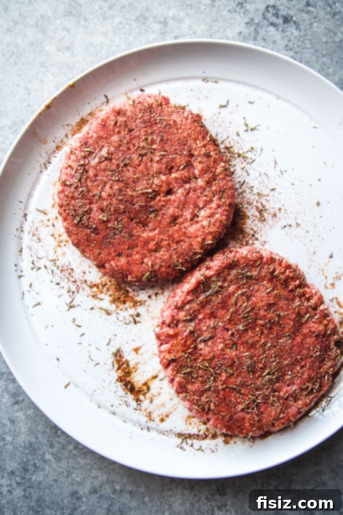 Creole Skillet Burger with Zesty Ranch Fries 5 Hand pressing raw creole seasoned burger patties