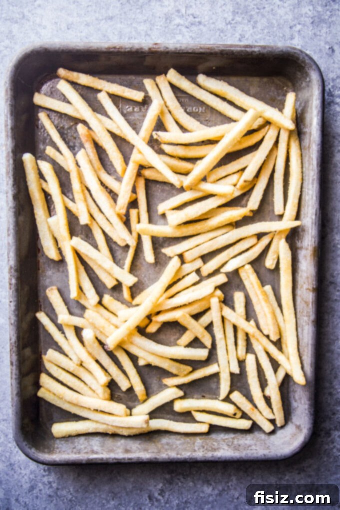 Creole Skillet Burger with Zesty Ranch Fries 7 Baked french fries on a baking sheet, ready for seasoning