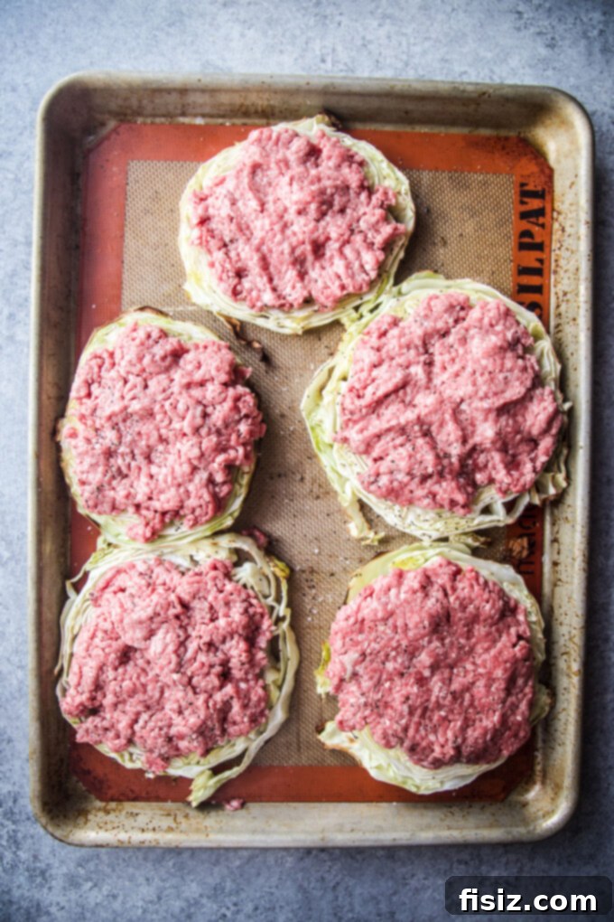 One Pan Cabbage Burgers 5 Roasted cabbage with ground beef patties on top, ready for cooking