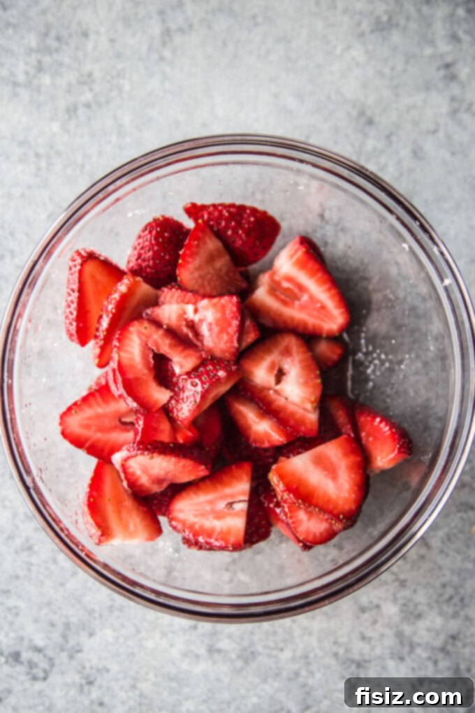 Strawberry Cardamom Protein Cake 5 strawberries in a bowl, ready for baking