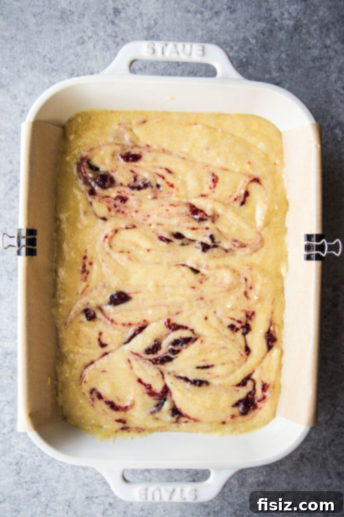 Strawberry Cardamom Protein Cake 7 batter with swirled jam for high-protein snack cake