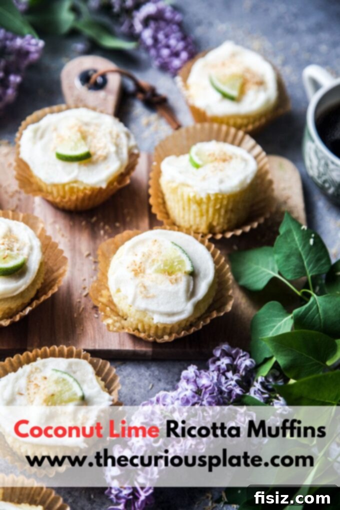 Two hands holding a Coconut Lime Ricotta Muffin, showing its inviting appearance and ready to be eaten.