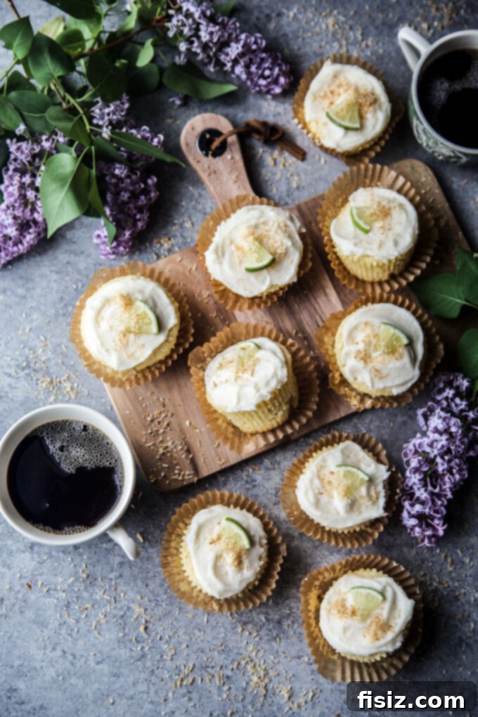 Close-up of a Coconut Lime Ricotta Muffin, showing its moist crumb and fluffy texture, topped with frosting.