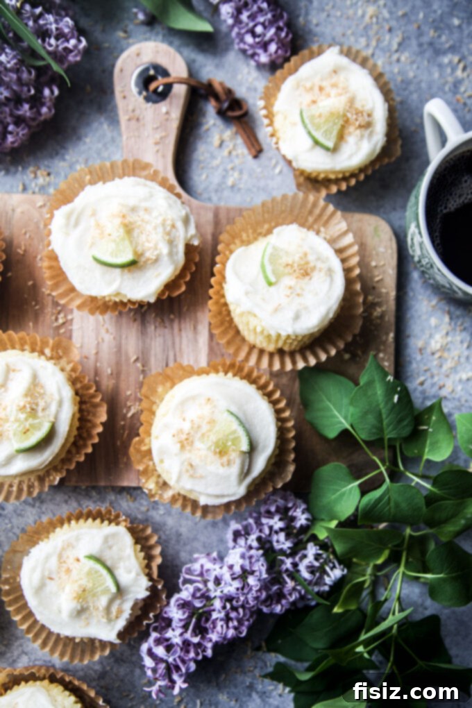 Three perfectly baked Coconut Lime Ricotta Muffins, showing their golden-brown tops and moist interior.
