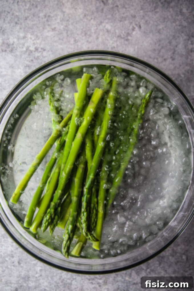 Effortless Asparagus Caesar 5 asparagus in a an ice bath