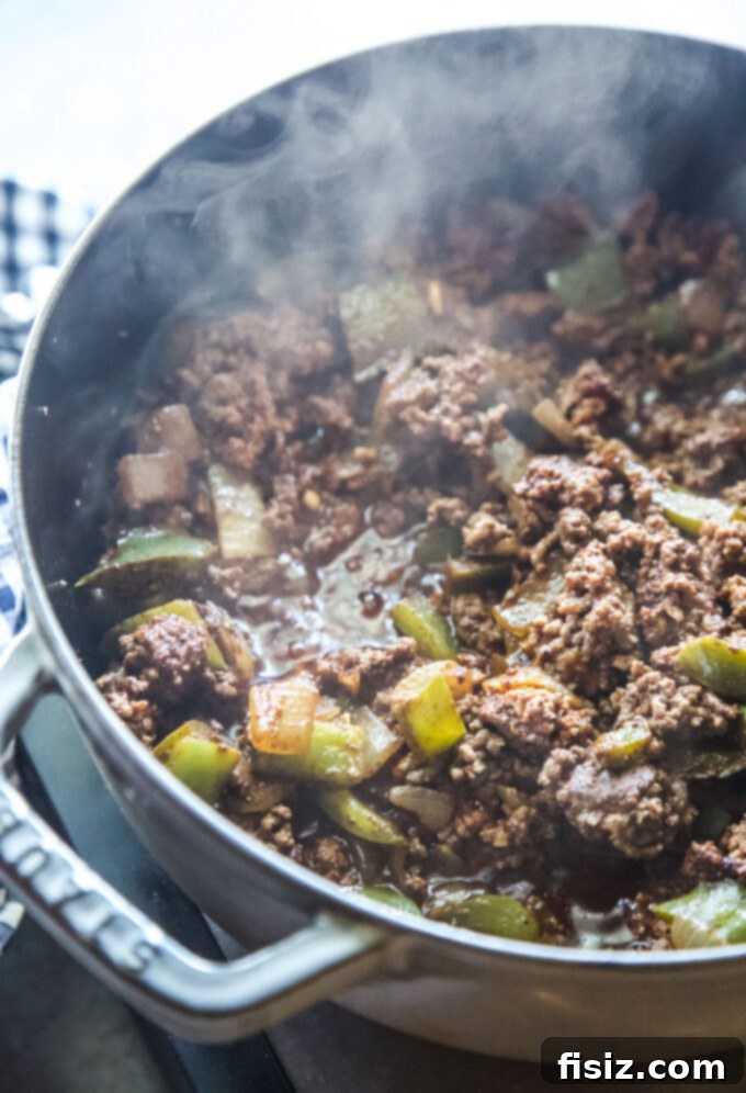 The Ultimate Classic Ground Beef Chili 5 ground beef and peppers in a pot