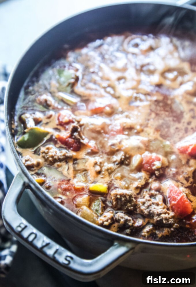 The Ultimate Classic Ground Beef Chili 7 all the beef ingredients simmering in a pot