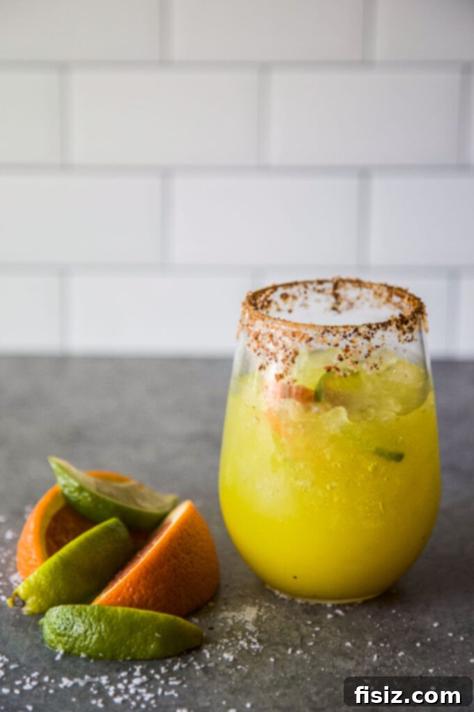 Beat the Bloat: 3 DIY Tonics for Thanksgiving Digestion 5 A glass of the finished Spiced Sunshine Tonic, garnished with chili oil and fresh mint, ready to be enjoyed for digestive comfort.