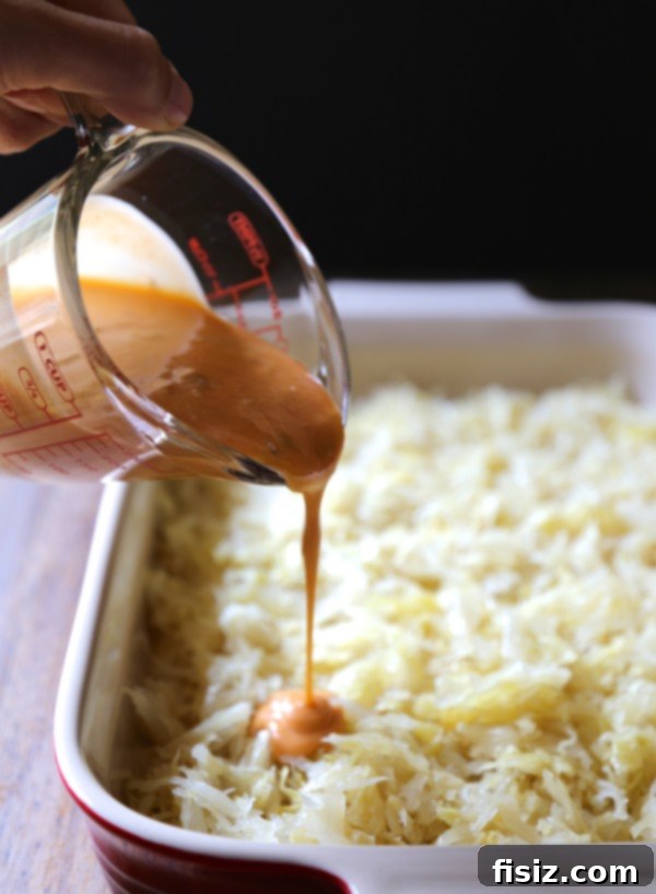 Double-Layered Flaky Reuben Bake with Brown Butter Rye Crumble 3 Double Layered Puff Pastry Reuben Casserole with Brown Butter Rye Breadcrumbs, presented in a ceramic baking dish