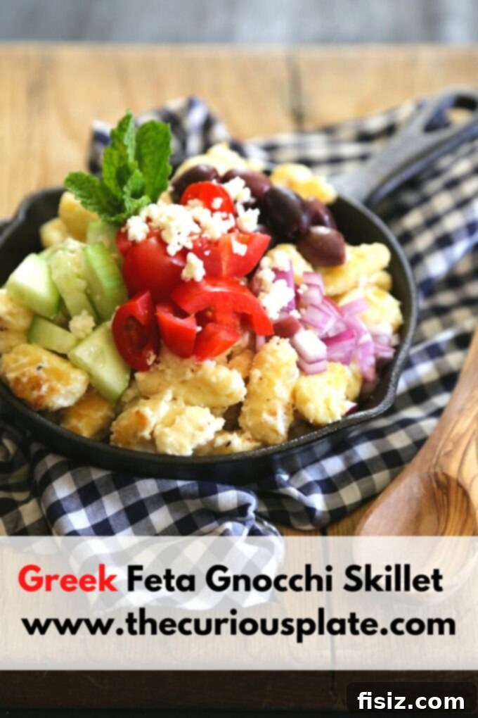 One-Pan Greek Feta Gnocchi 5 An overhead shot of the finished Greek Feta Gnocchi Skillet, vibrant with fresh vegetables and creamy feta, presented in a cast-iron pan on a rustic wooden surface.