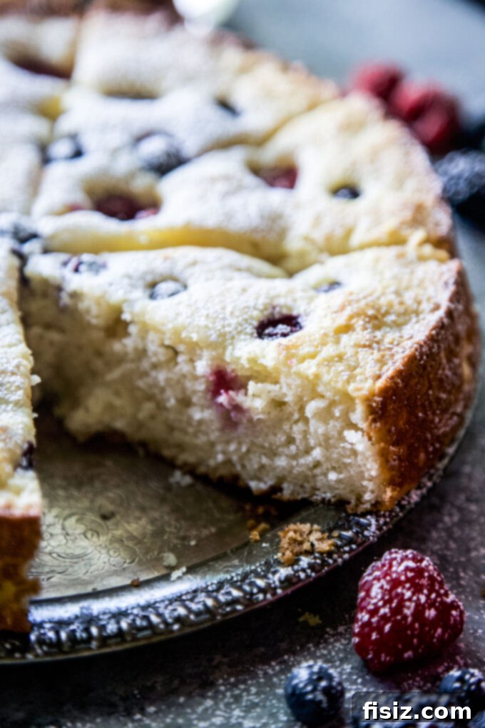 Effortless Berry Ricotta Delight 10 A full Ricotta Cake with Fresh Berries on a cooling rack, ready to be stored or served