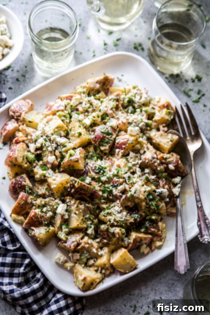 Loaded BBQ Bacon Blue Potato Salad 9 Serving of Barbecue, Bacon, and Blue Cheese Potato Salad garnished with fresh herbs
