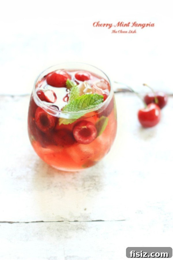 Rich Cherry Mint Sangria with Kirschwasser, garnished with fresh cherries