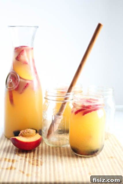 Sparkling Peach and Strawberry Sangria in a champagne flute
