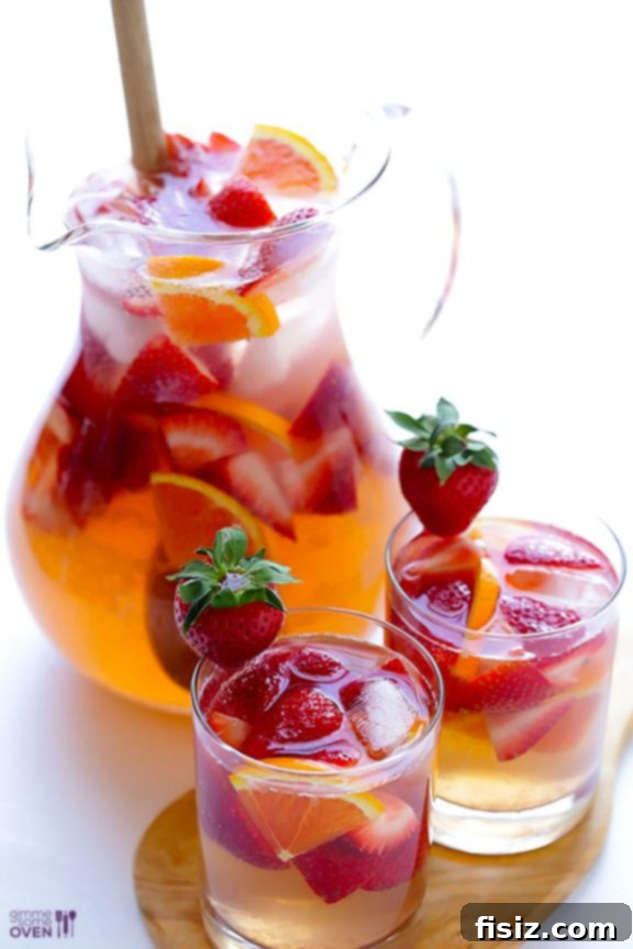 Refreshing Strawberry Sangria in a tall glass with ice