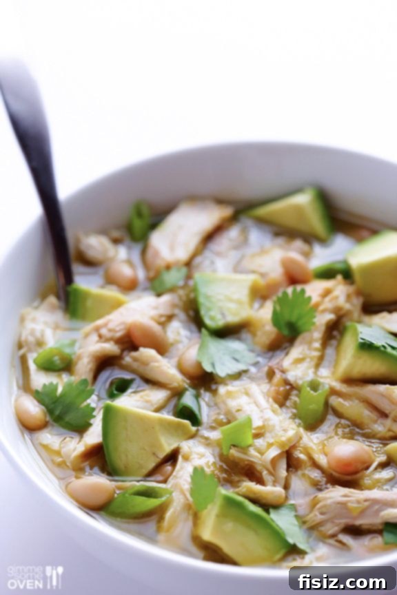 10 Ultimate Tailgate Chili Recipes 5 Creamy white chicken chili in a bowl with a spoon.