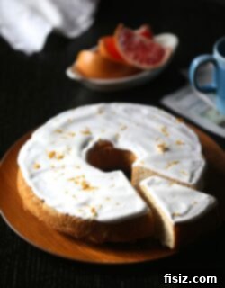 Finished Grapefruit Pound Cake with Ginger Marshmallow Icing, garnished with zest