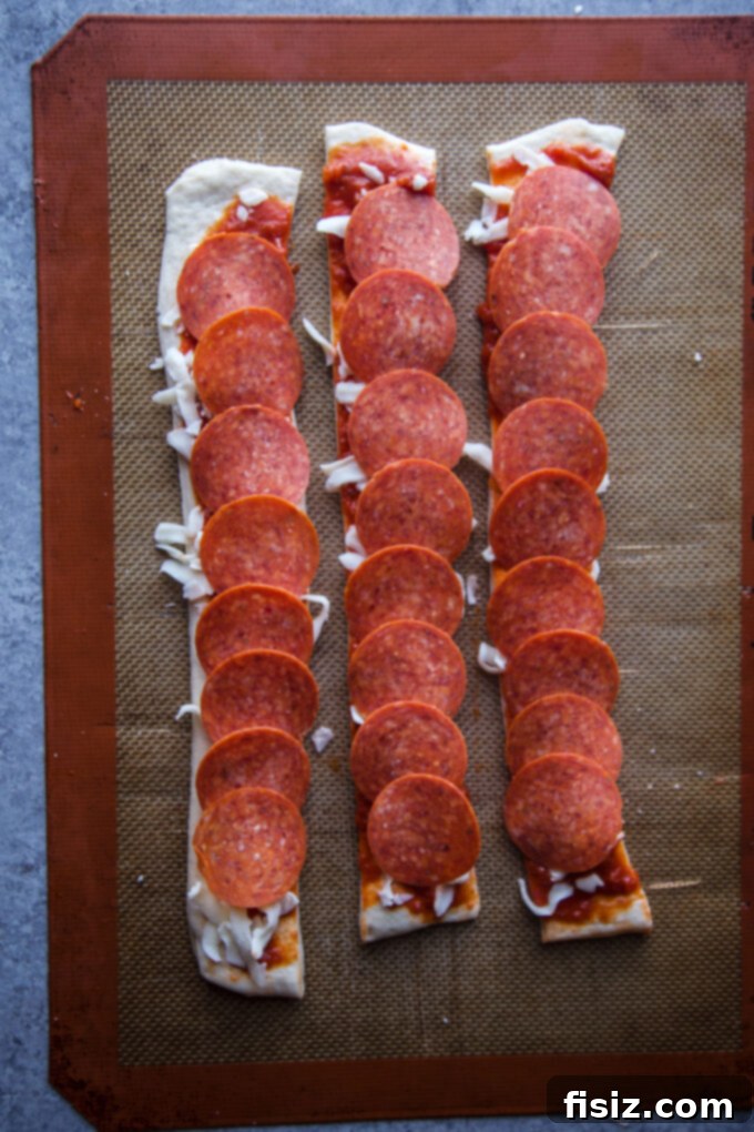Pizza dough topped with pepperoni